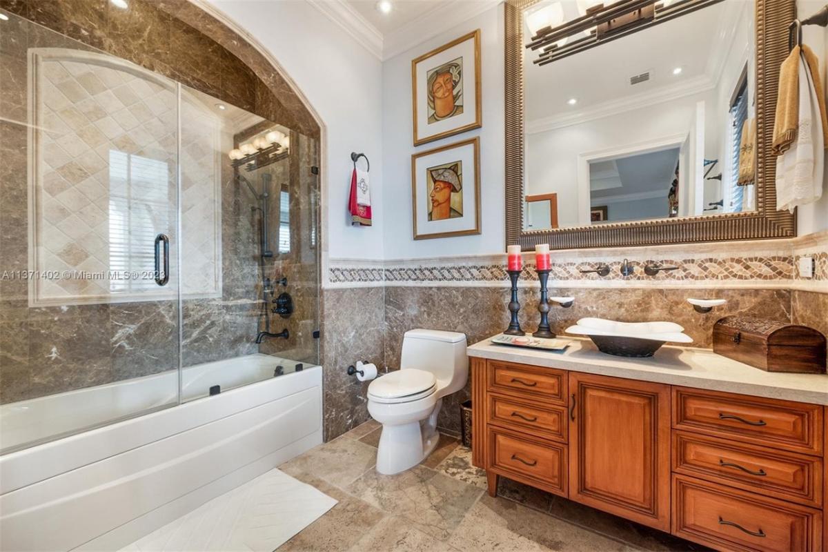 Bathroom with a sink, toilet and a walk-in shower.