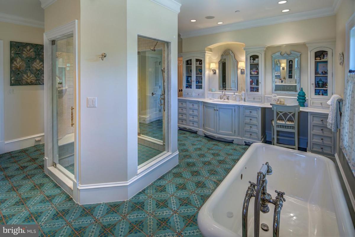 Bathroom with a custom-made vanity, soaking tub and a walk-in shower