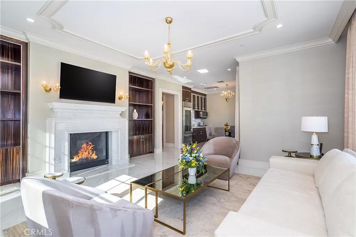 Living room with a chandelier and a fireplace.