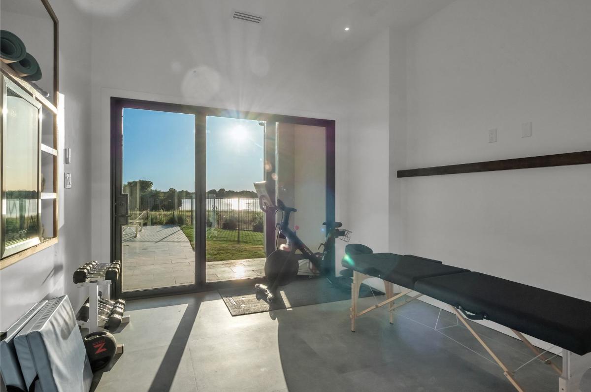 Home gym with glass doors.