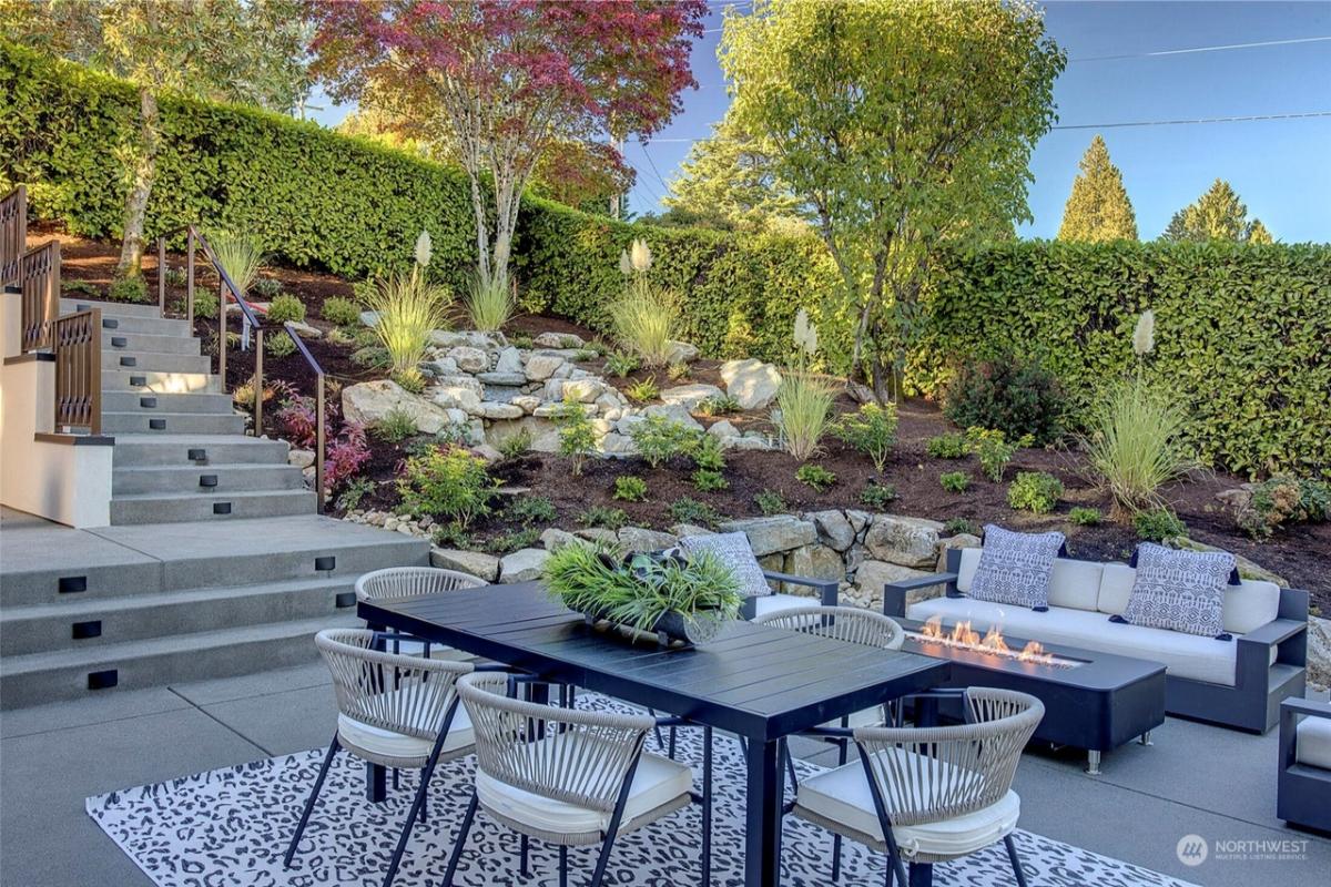 Fire pit with couches and a dining table.