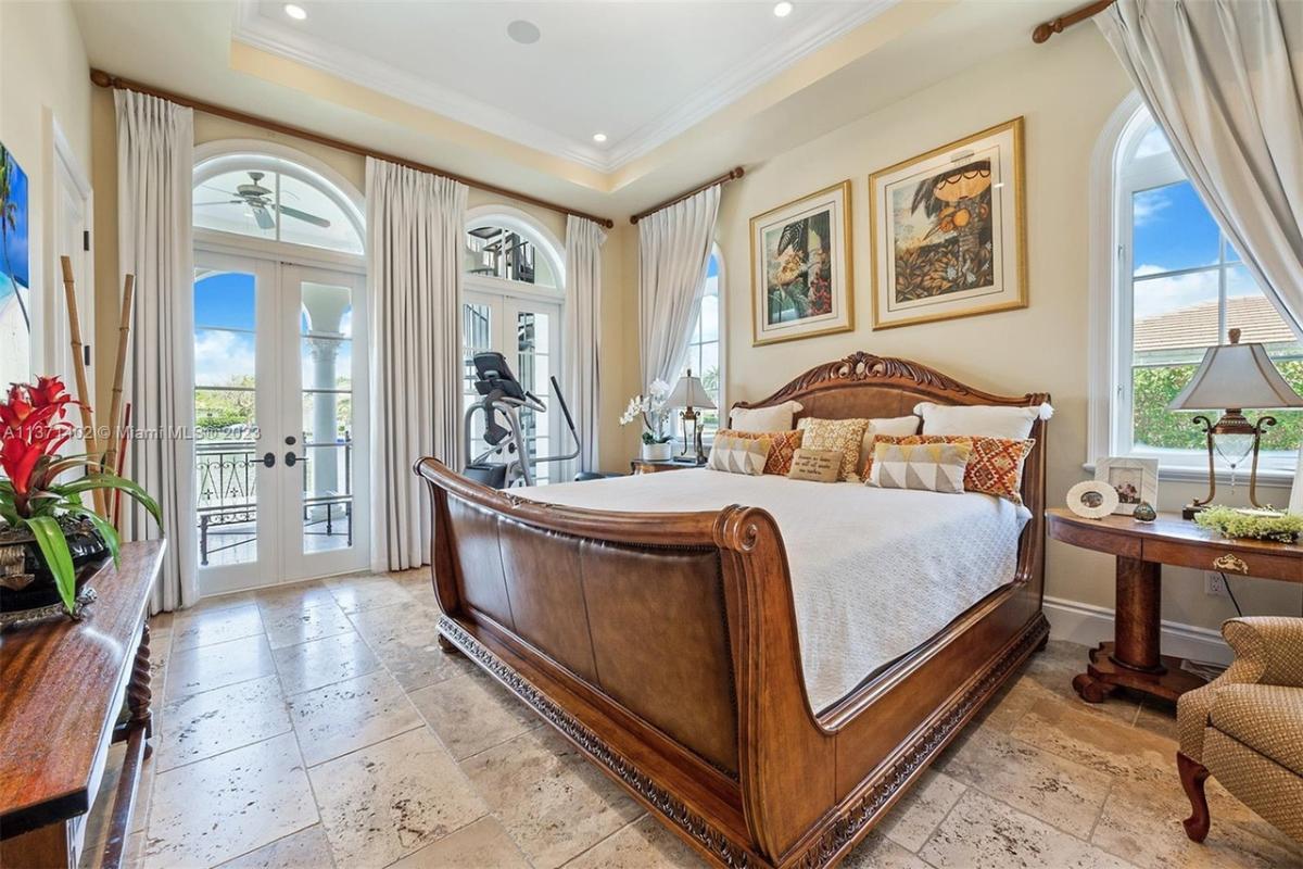 Bedroom with a large bed and marble flooring.