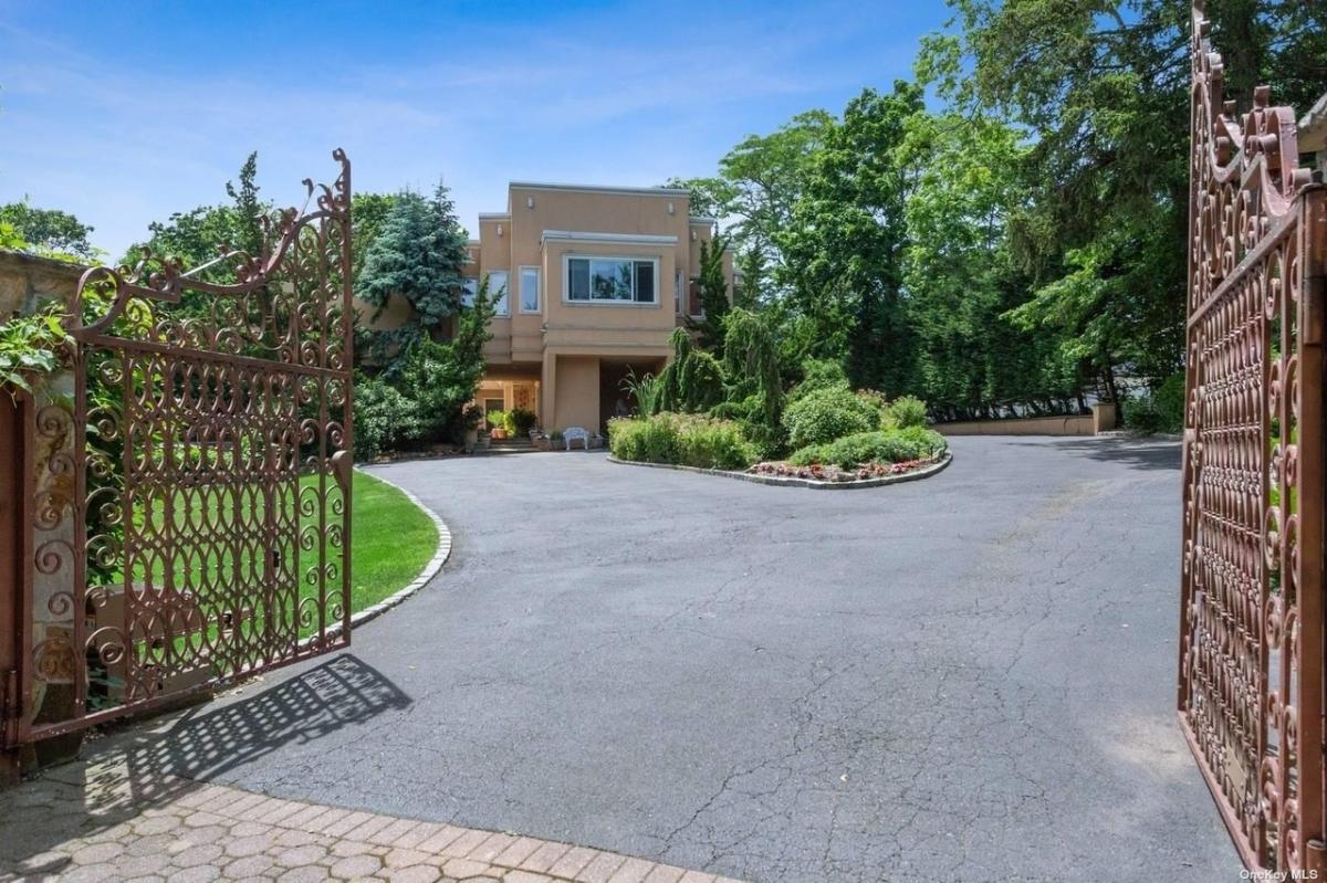 Main gate entry of the mansion with landscaped yard.
