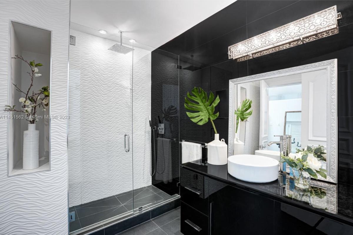 Bathroom with a custom-made vanity and a walk-in shower.