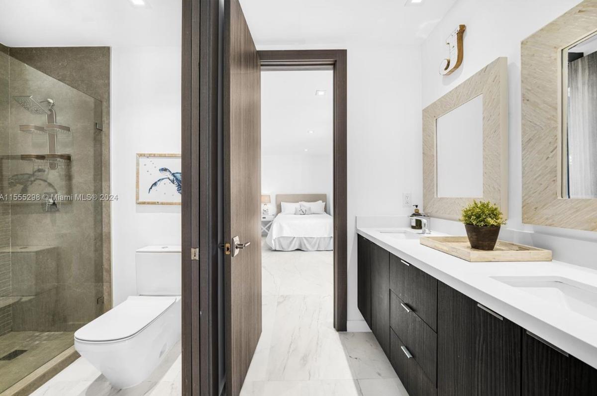 Bathroom with a sink, toilet and a walk-in shower.