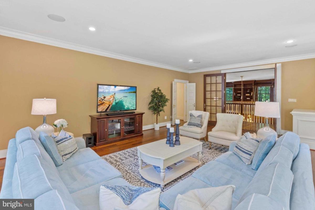 Family room with couches and a TV.
