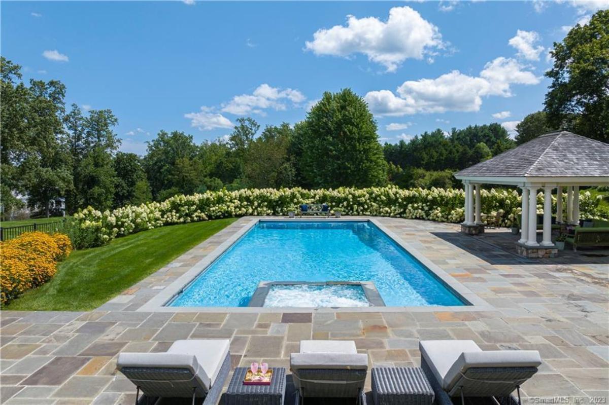 Pool with lounge chairs and a cabana.