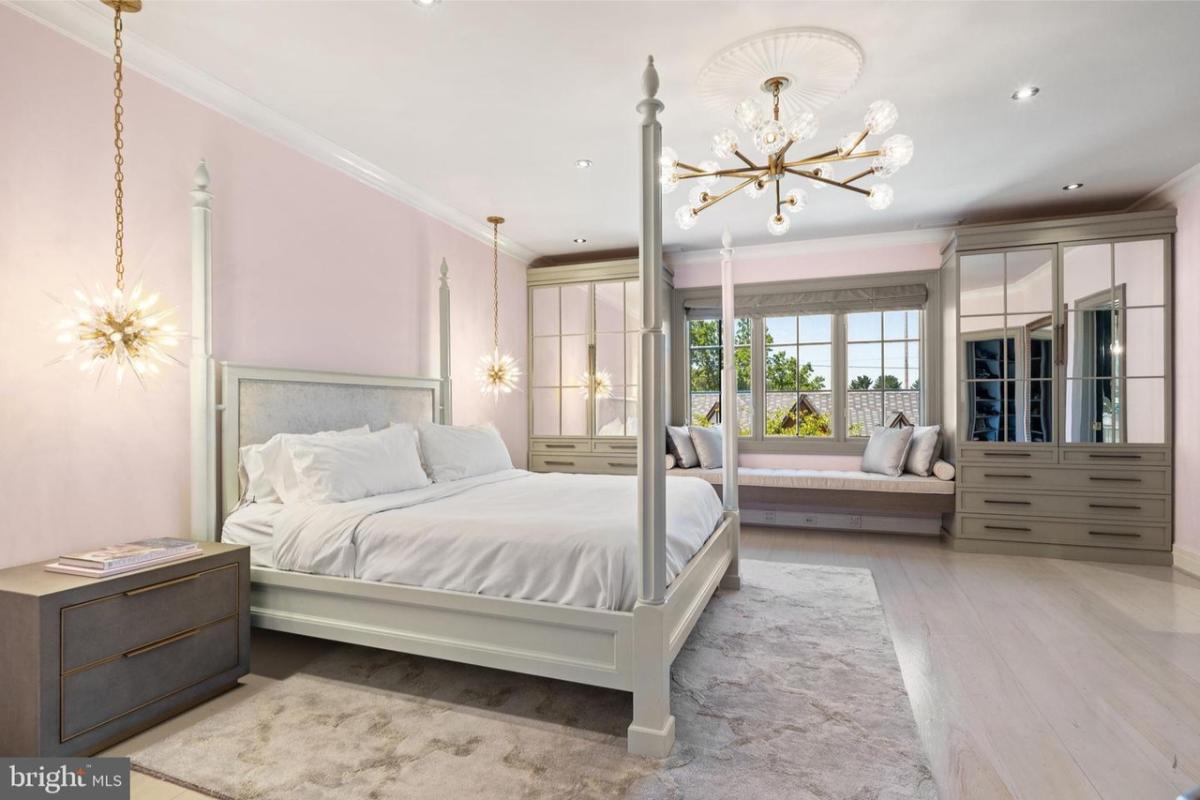 Bedroom with hardwood floors and custom lighting.