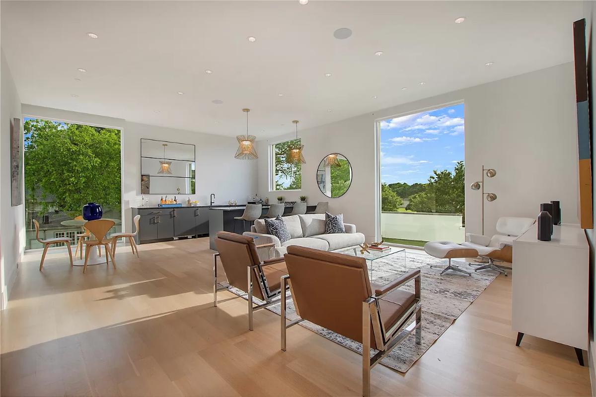 Living room with couches, tables and chairs.