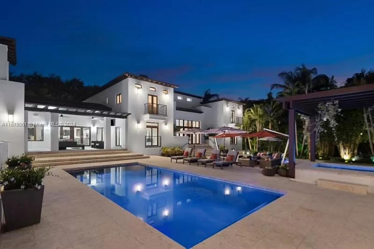 Rear view of the mansion with a pool.