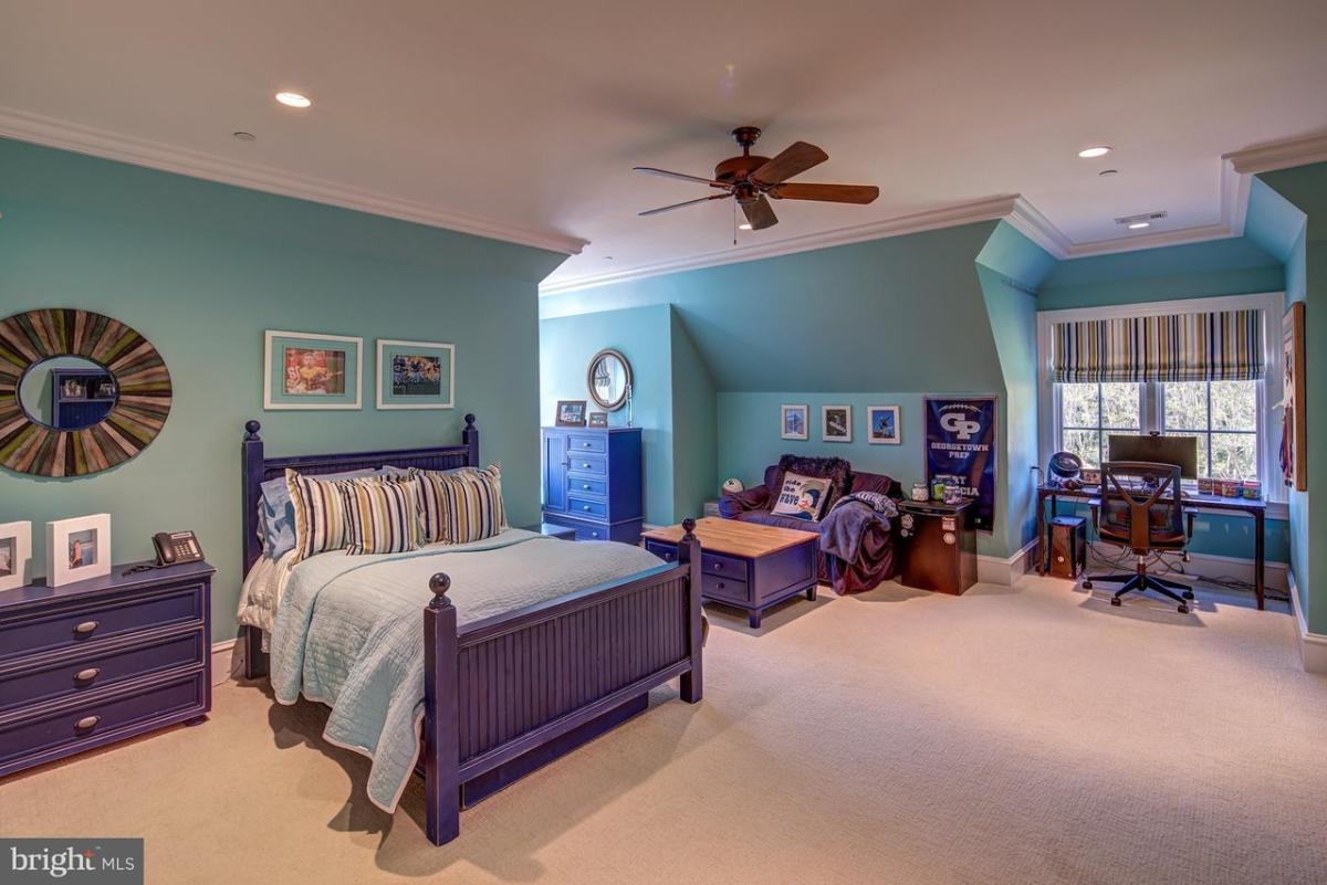 Bedroom with carpet flooring and a private living space.