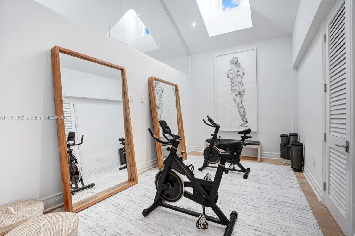 Home gym with huge mirrors.