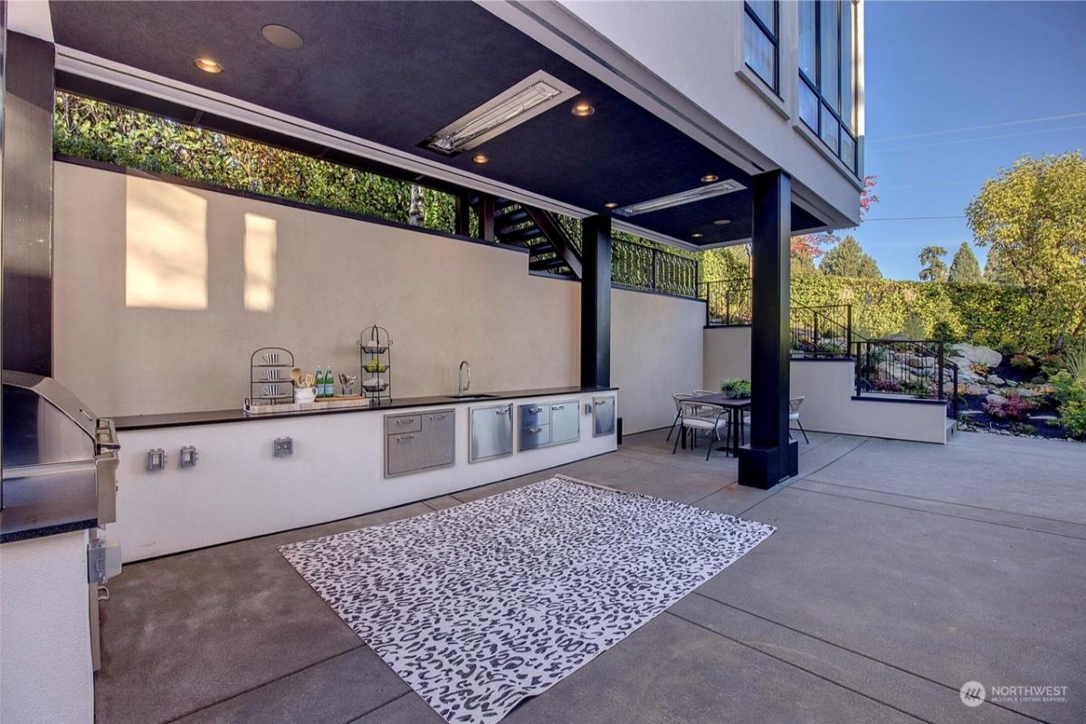 Grill area with a dining table and chairs.