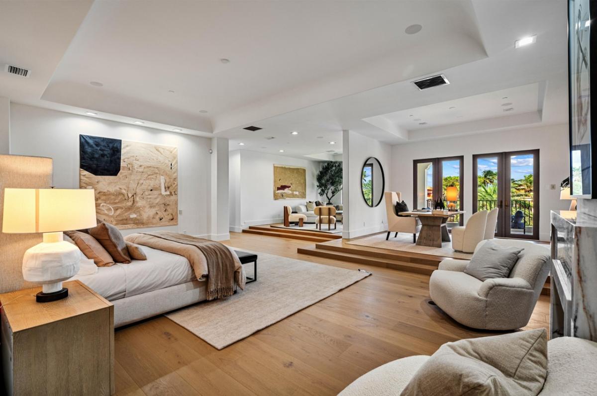Bedroom with private living space and a home office.
