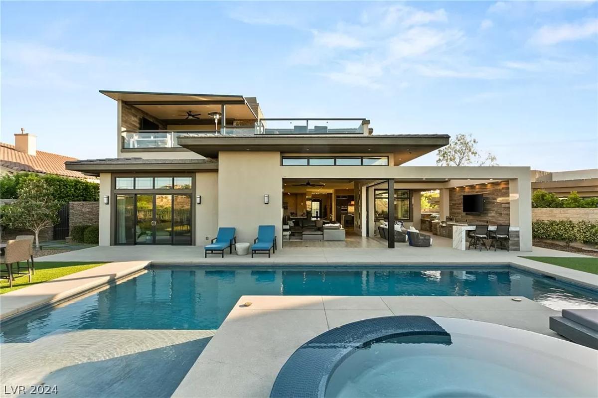 Rear view of the mansion with a pool.
