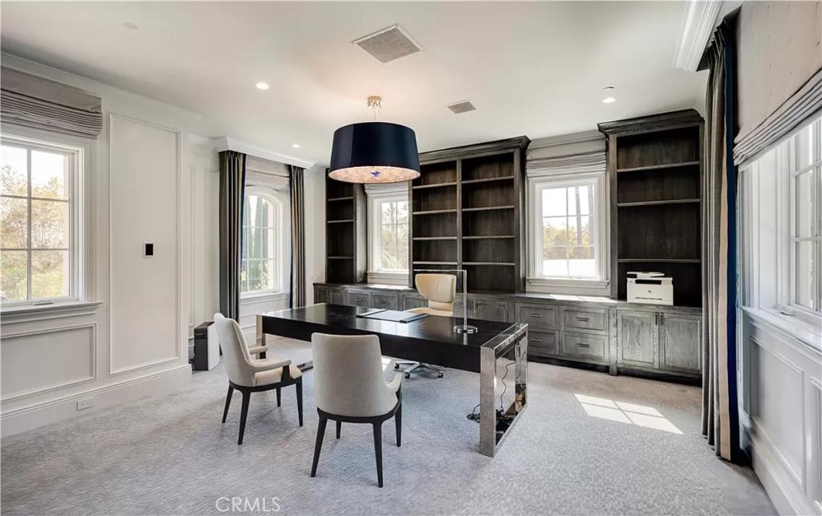 Home office with bookshelves and custom lighting.