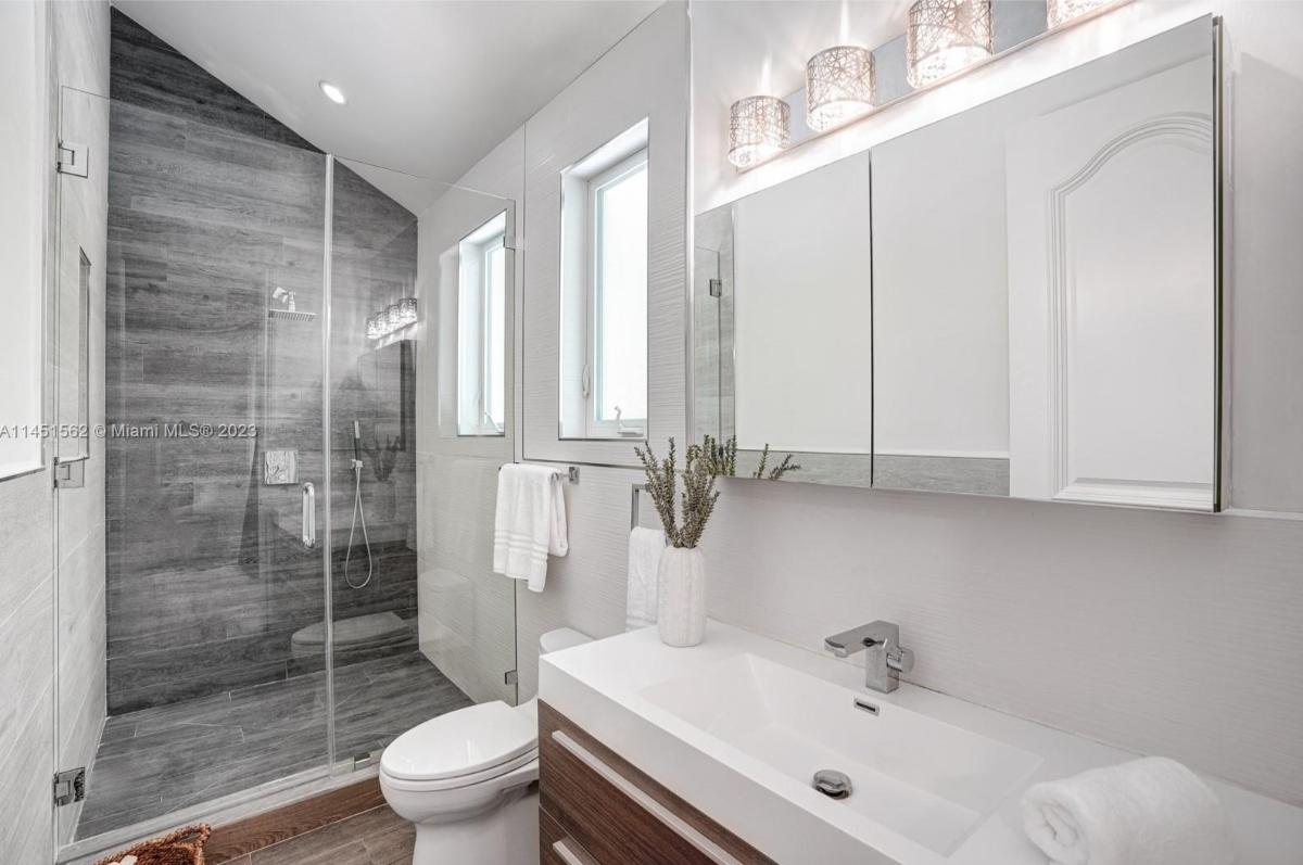 Bathroom with a sink, toilet and a walk-in shower.