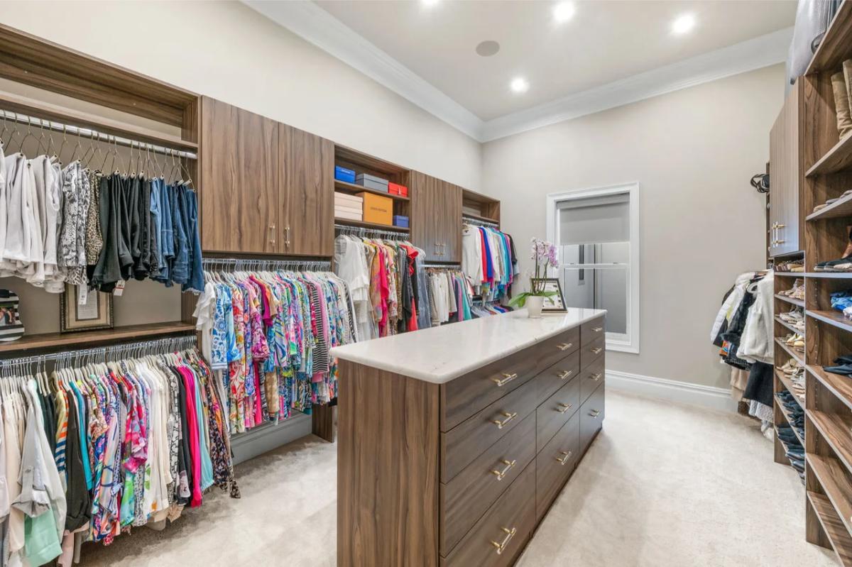 Walk-in closet with carpet flooring.