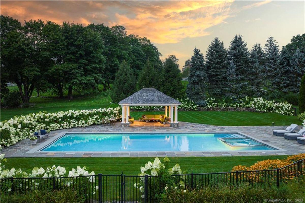 Pool with lounge chairs and a cabana.
