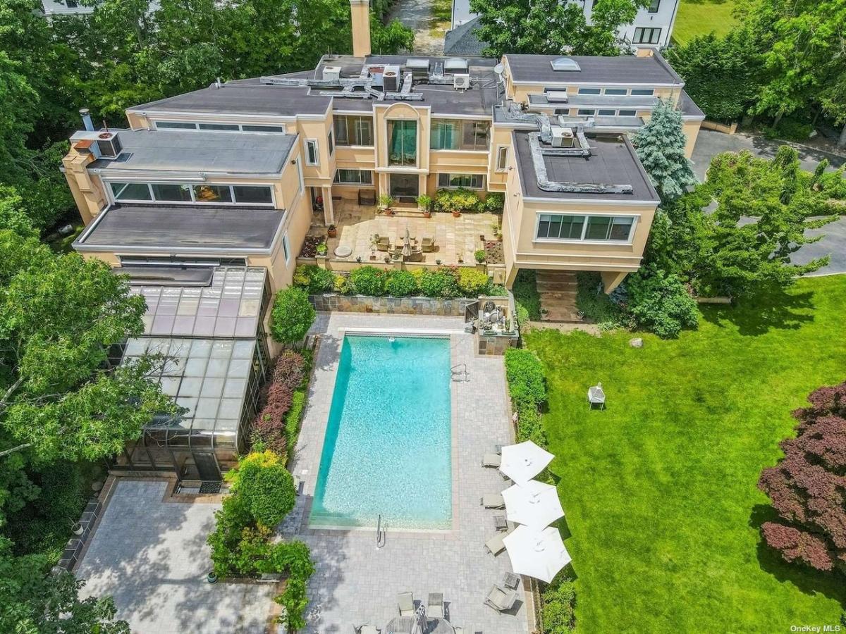 Aerial view of the mansion with a pool.