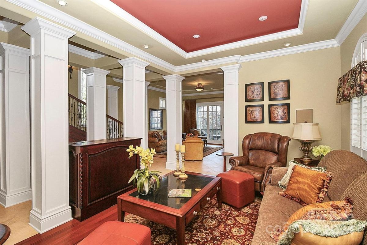 Living room with couches and custom lighting.