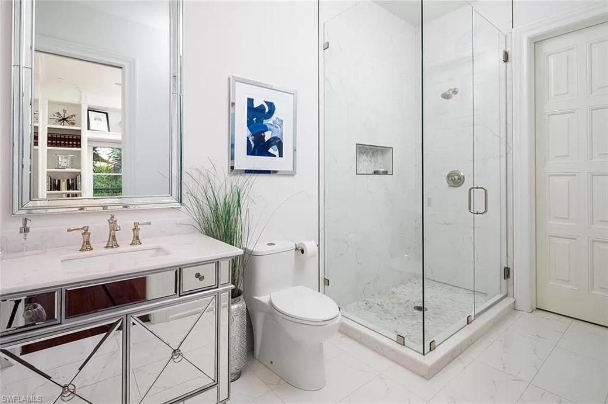 Bathroom with a sink, toilet and a walk-in shower.