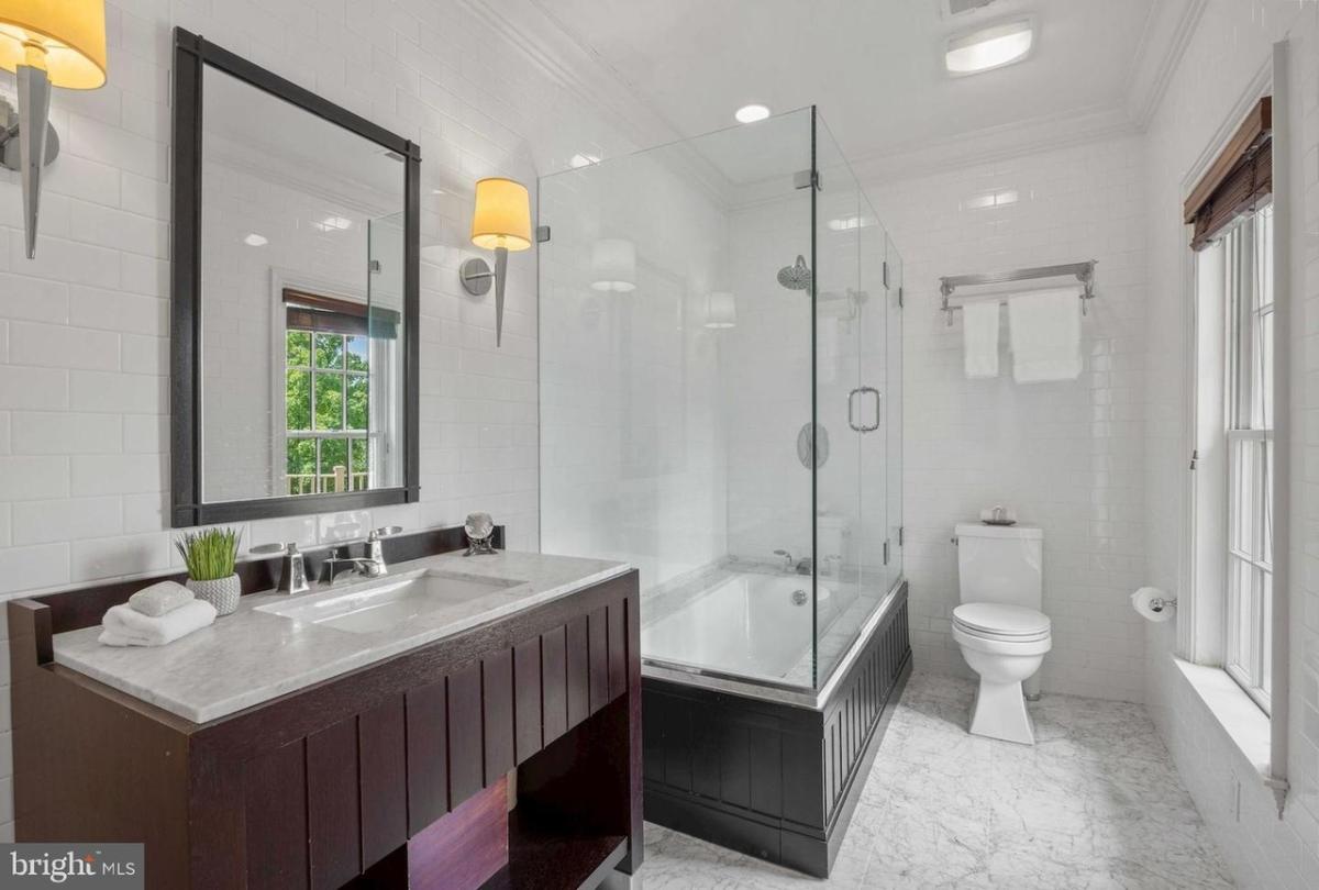 Bathroom with a sink, toilet and a walk-in shower.
