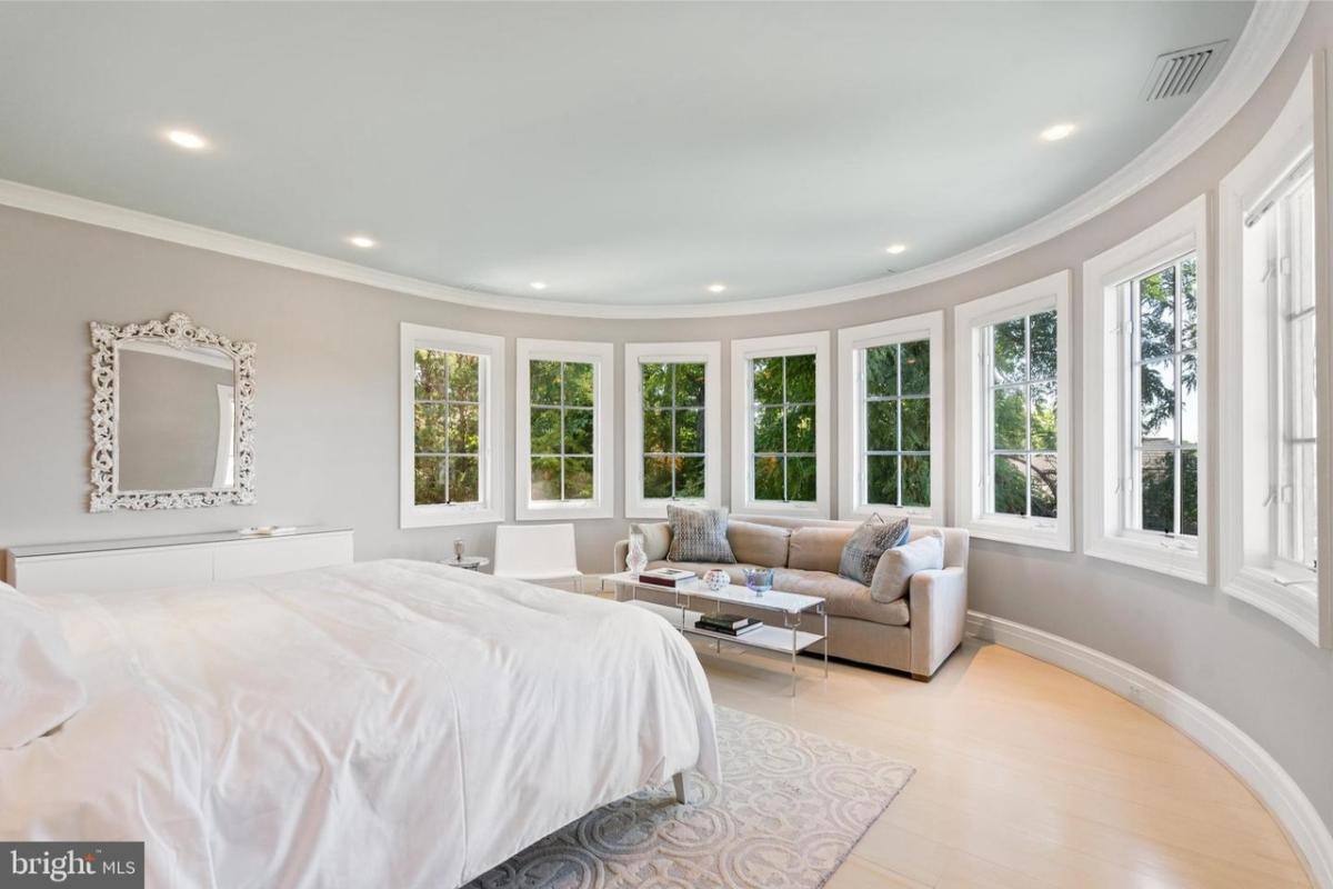 Bedroom with hardwood floors and glass windows.