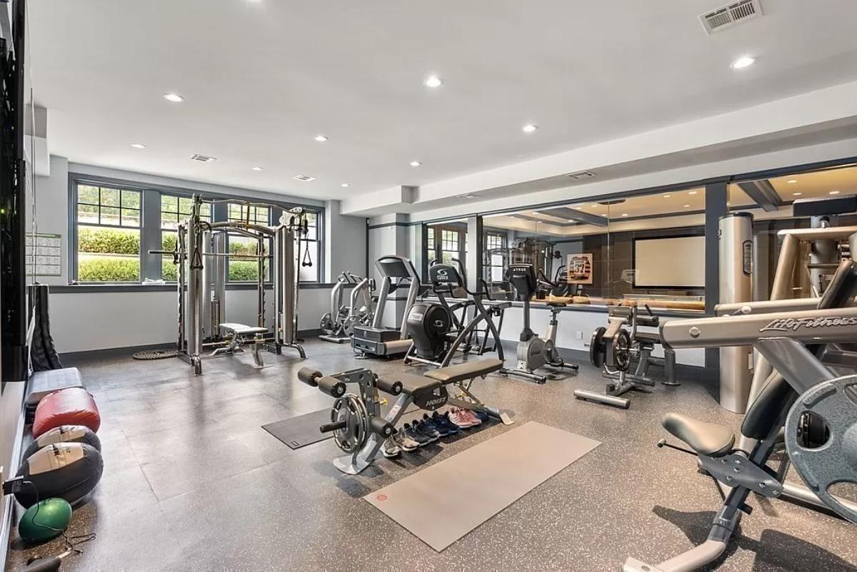 Home gym with large mirrors.