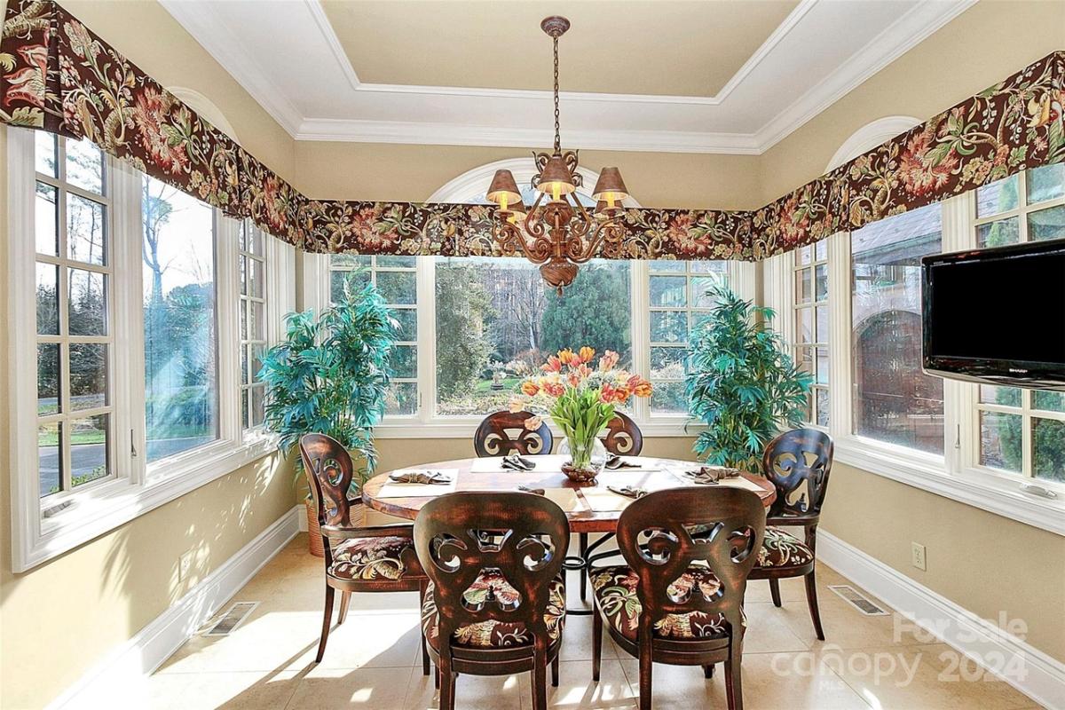 Dining room with glass windows and a TV.