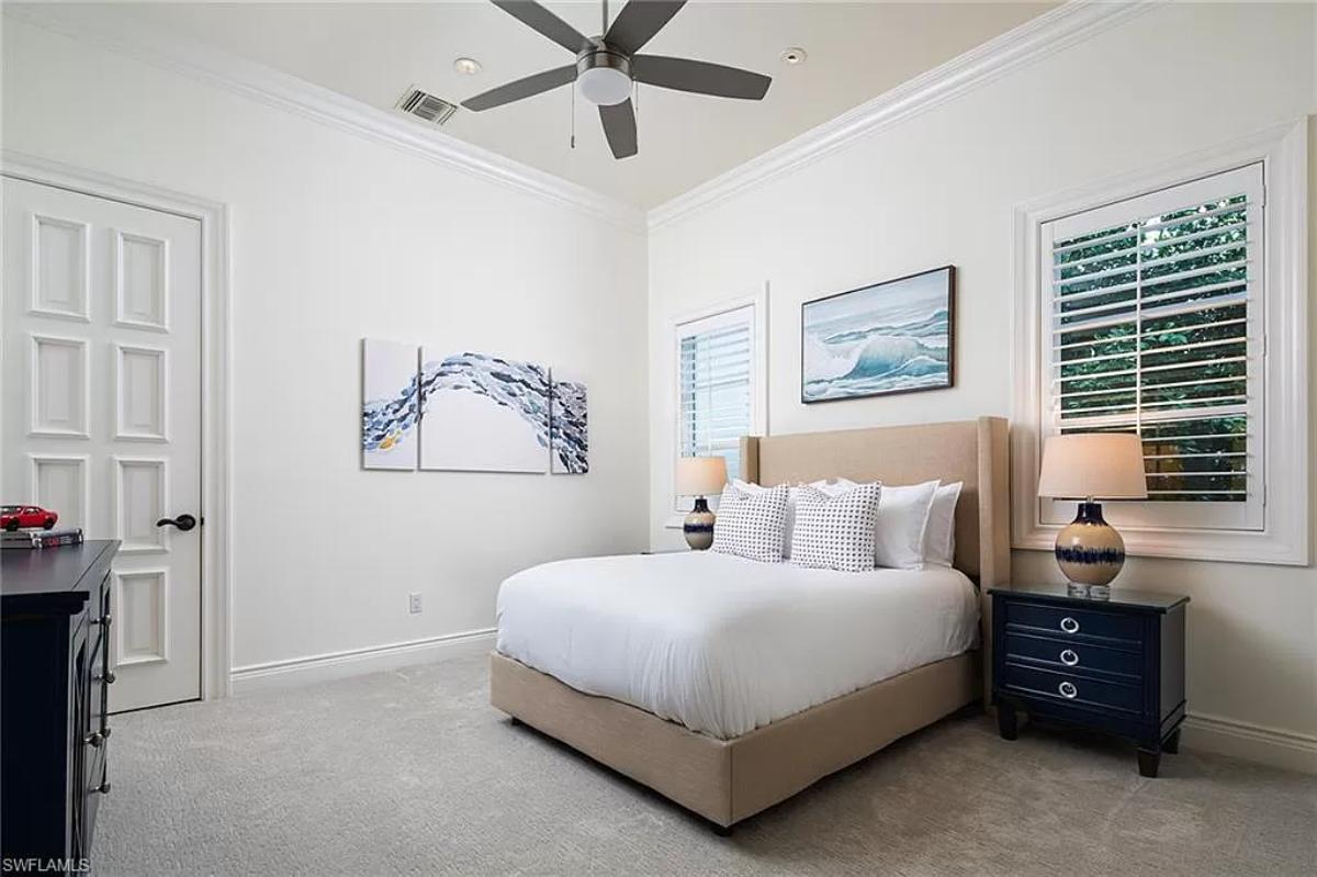 Bedroom with a large bed and carpet flooring.