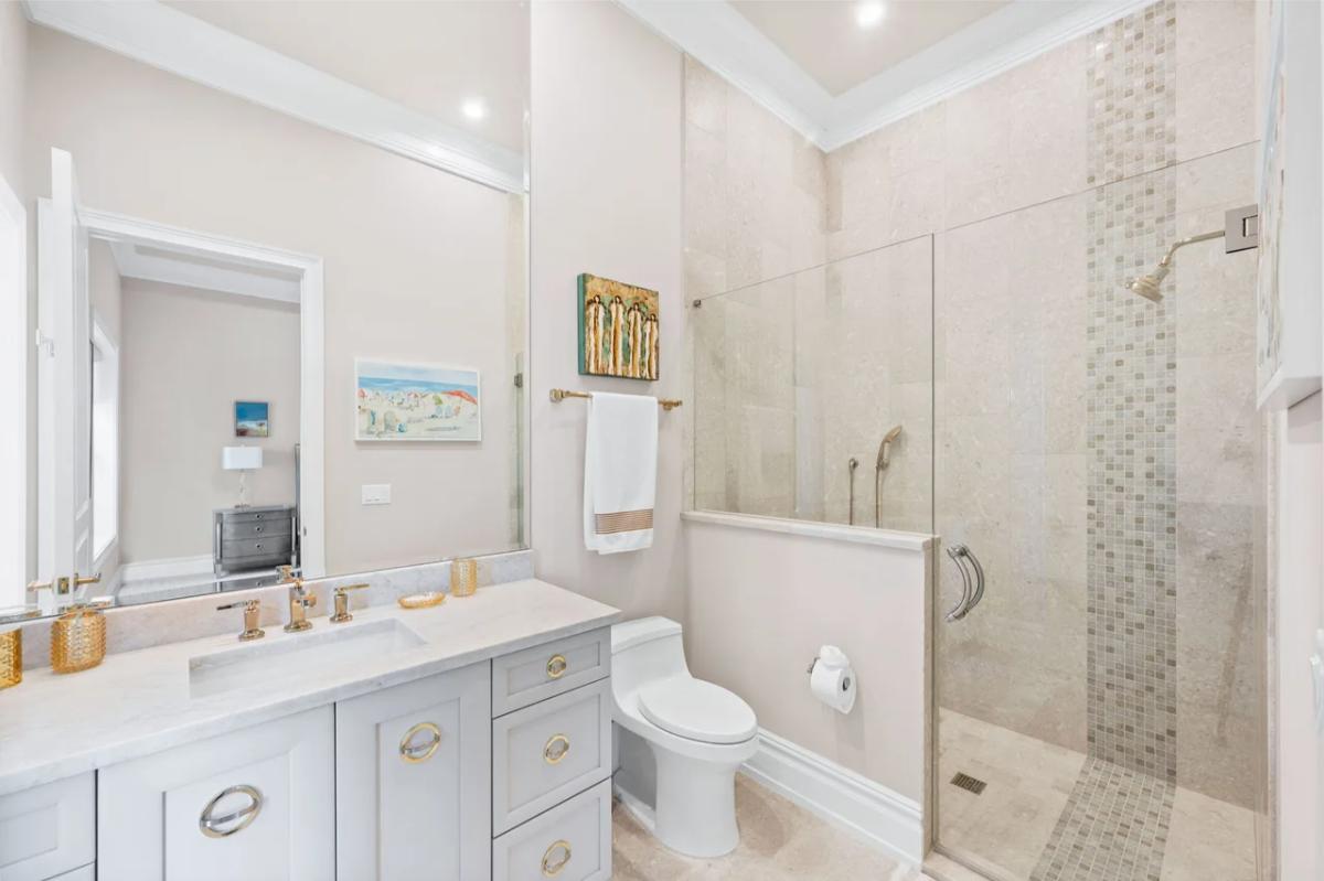 Bathroom with a sink, toilet and a walk-in shower.