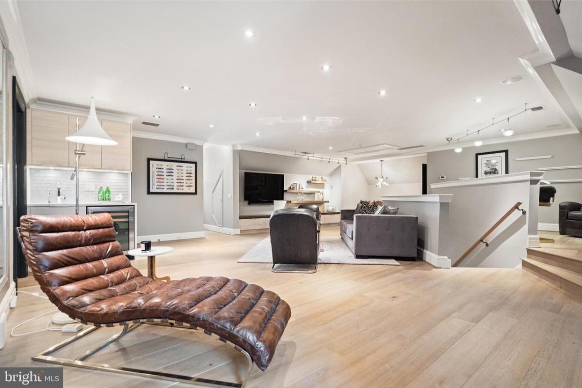 Family room with couches, TV, and custom lighting.