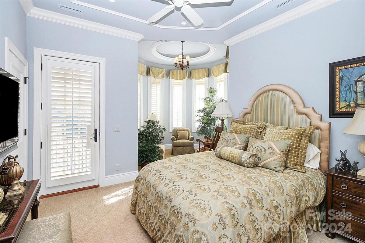 Bedroom with carpet flooring and a large bed.