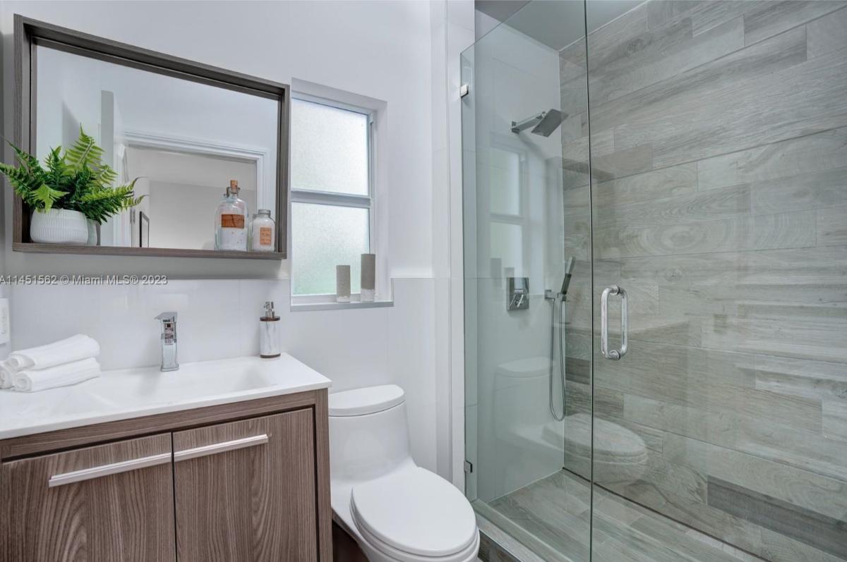 Bathroom with a sink, toilet and a walk-in shower.