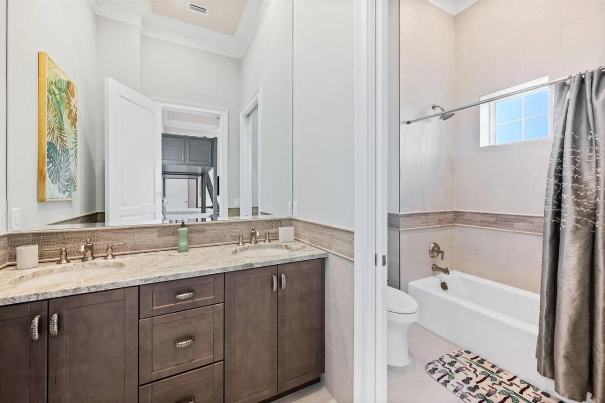 Bathroom with a sink, toilet and a soaking tub.