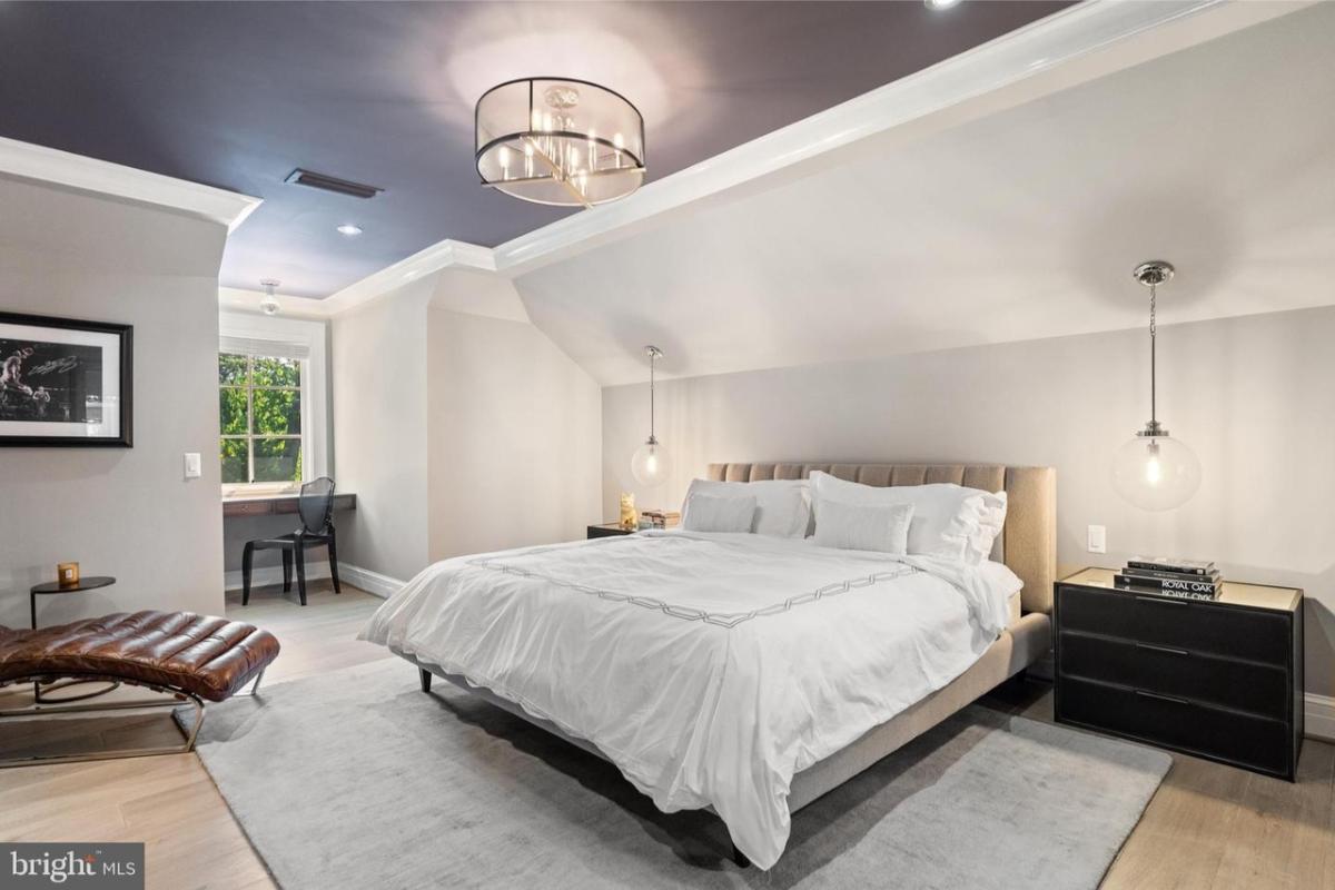 Bedroom with a large bed and custom lighting.