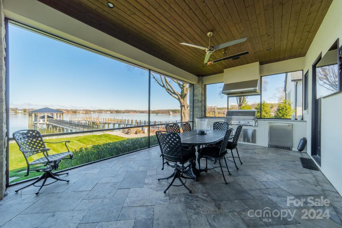 Grill area with a dining table and chairs.