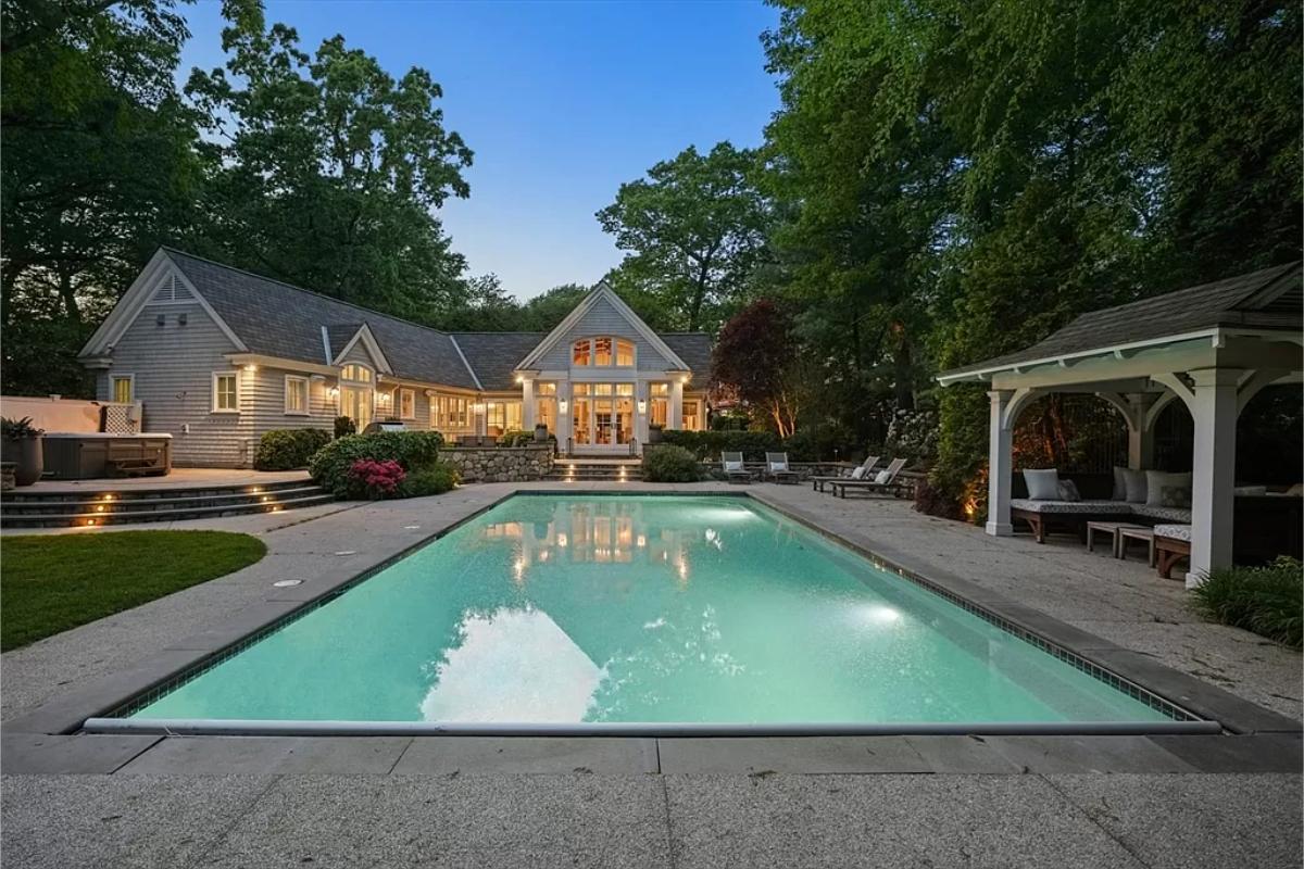 Pool with lounge chairs and a cabana.