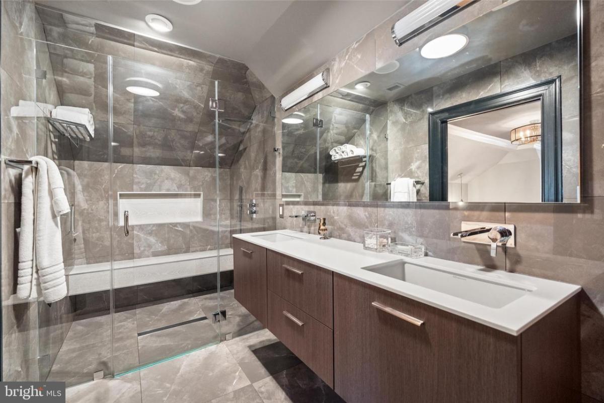 Bathroom with a custom-made vanity and a walk-in shower.