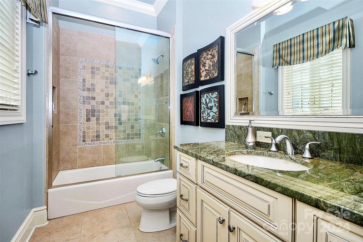 Bathroom with a sink, toilet and a walk-in shower.