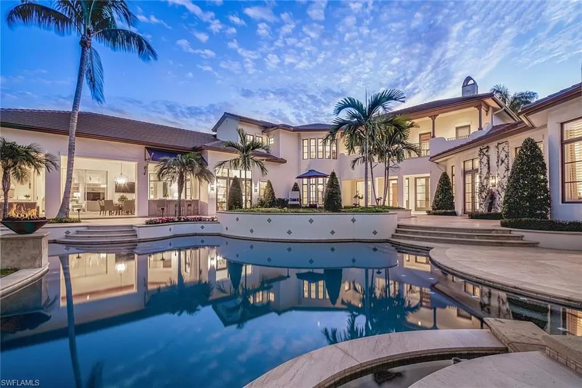 Rear view of the mansion with a pool.