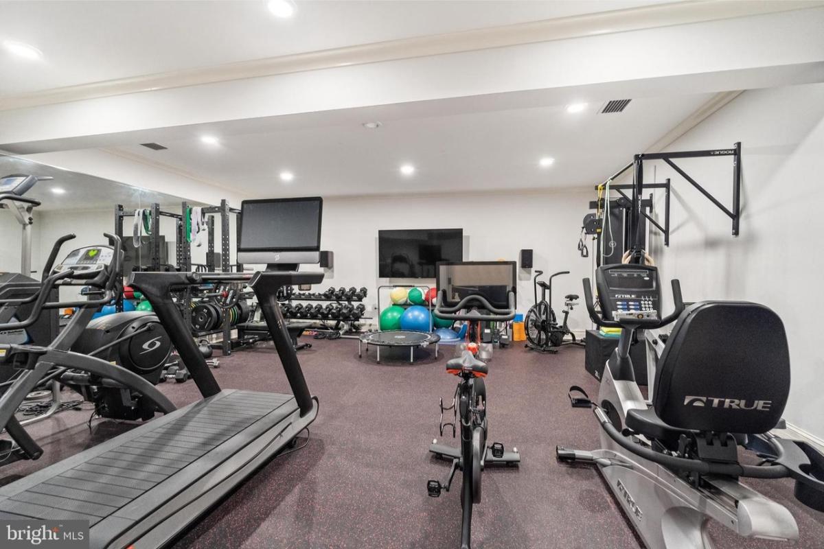 Home gym with lots of workout equipment.