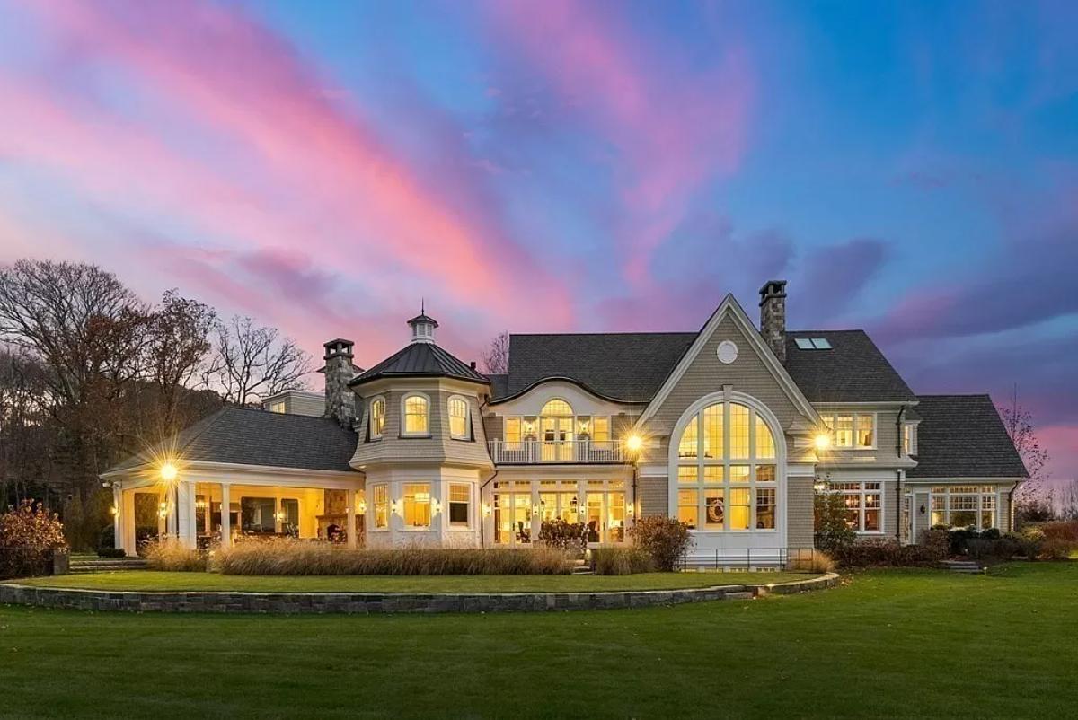 Rear view of the mansion with a huge green lawn.