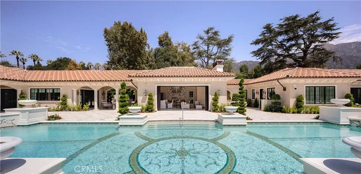 Rear view of the mansion with a pool.