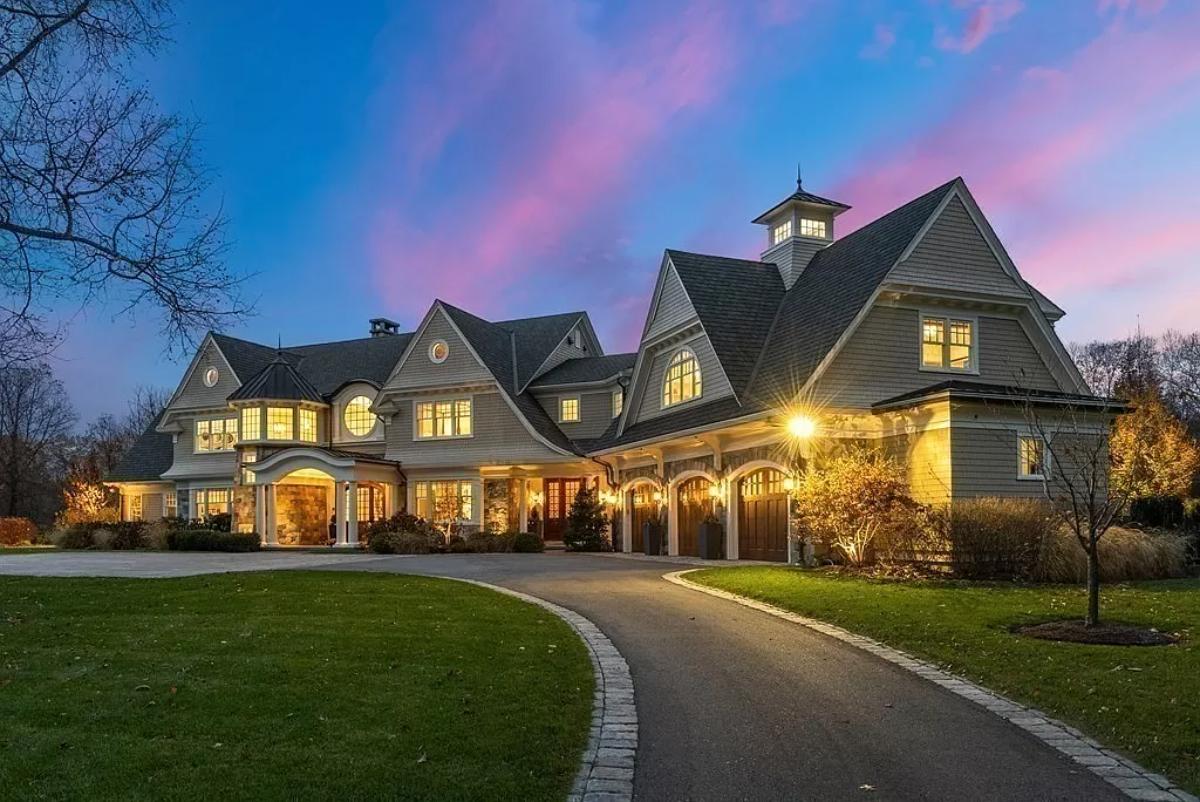 Front view of the mansion with a spacious driveway.