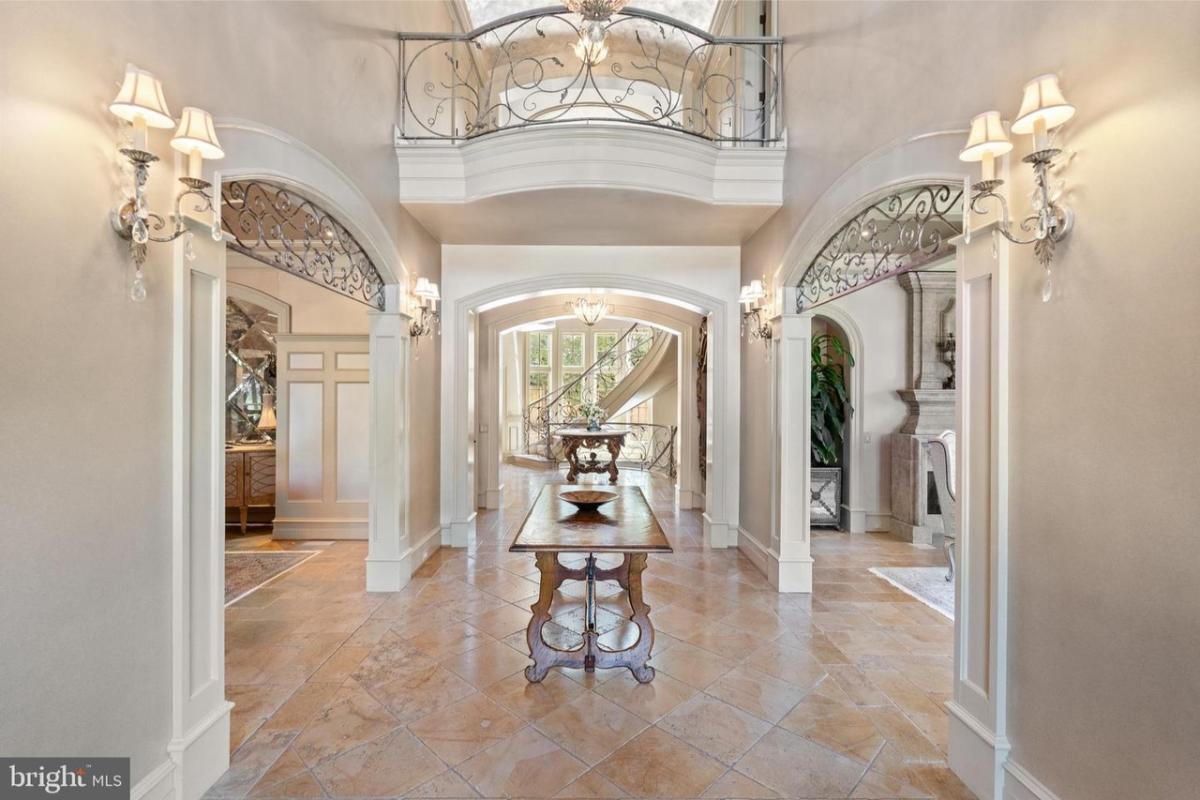 Foyer with a wood table and custom lighting.
