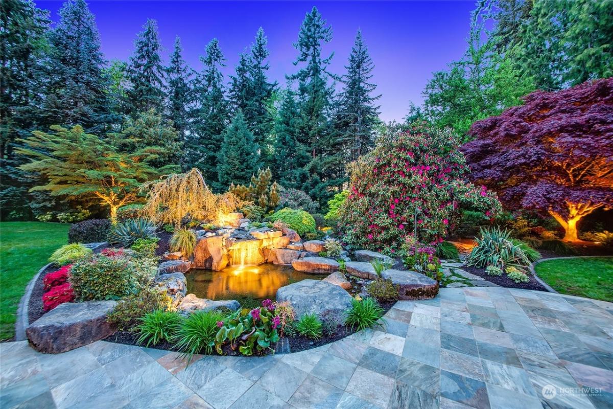 Waterfalls in a landscaped backyard.