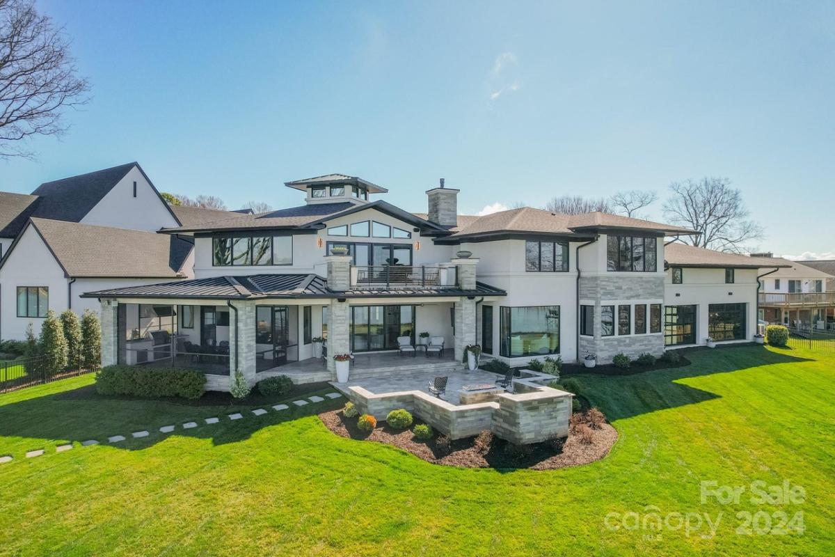 Aerial rear view of the mansion with a huge green lawn.
