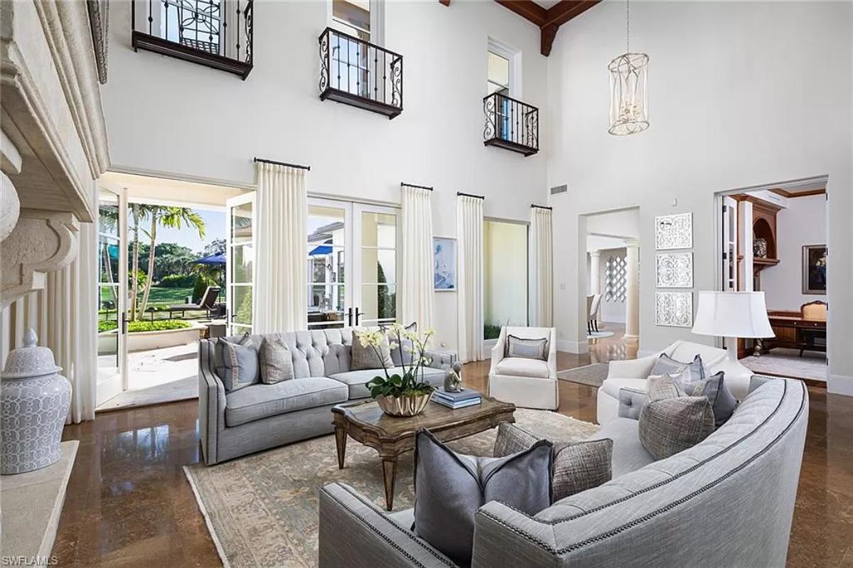 Living room with marble tiles and glass doors.